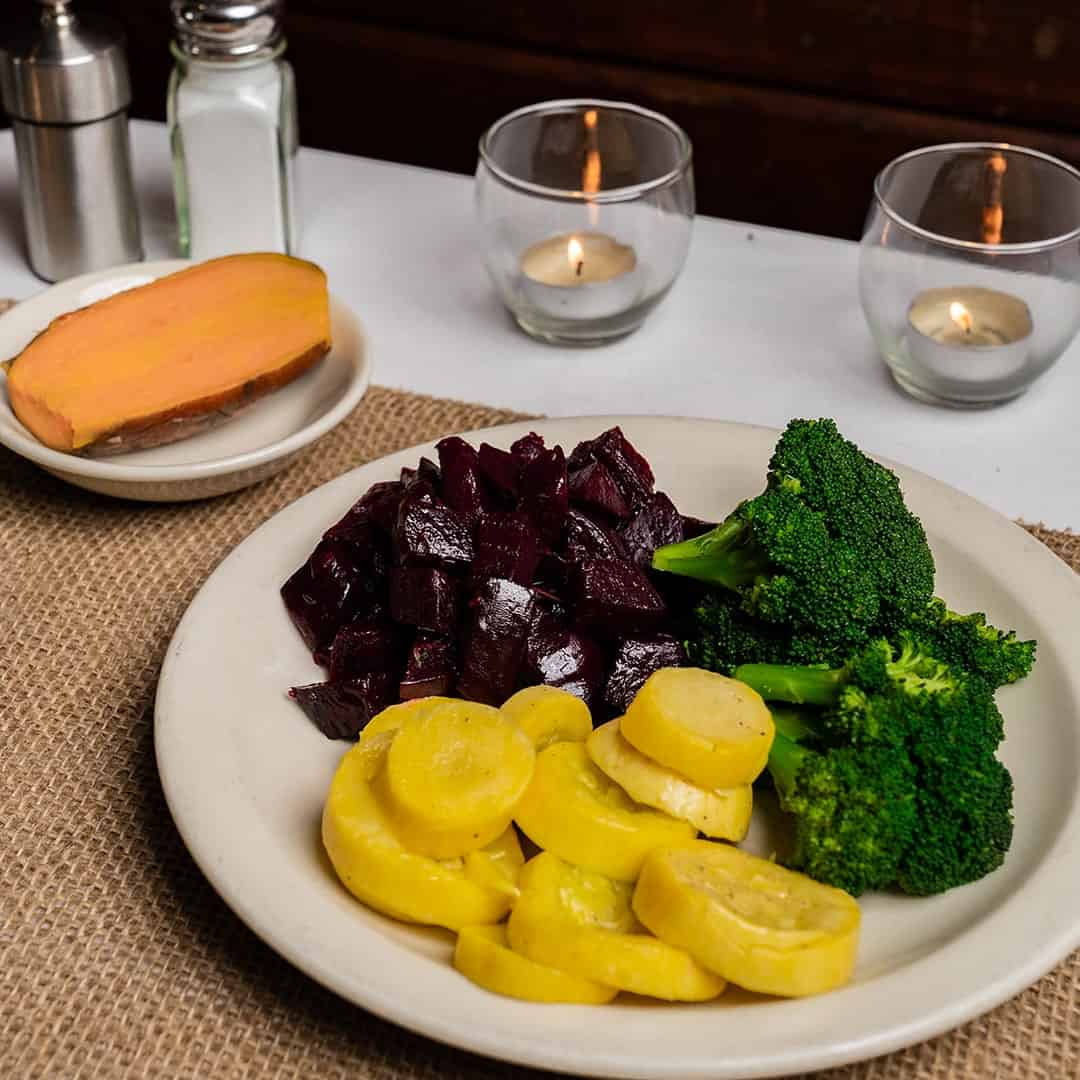 Family-style vegetables of beets, squash and broccoli at Celebration Restaurant in Dallas