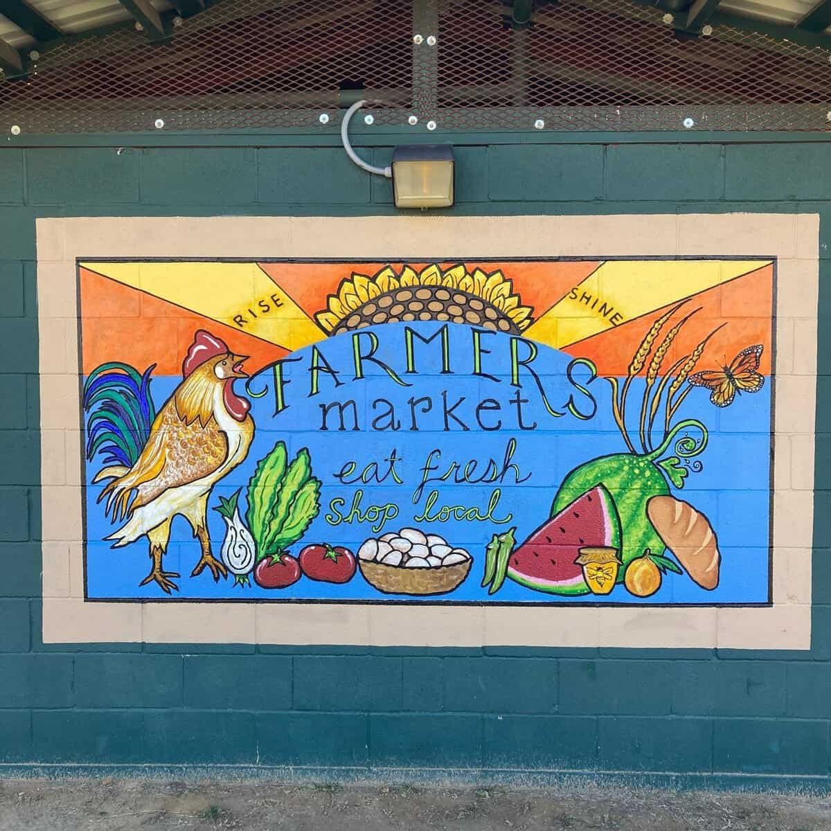 Colorful farmers market mural painted on the pavilion wall in Palestine, Texas
