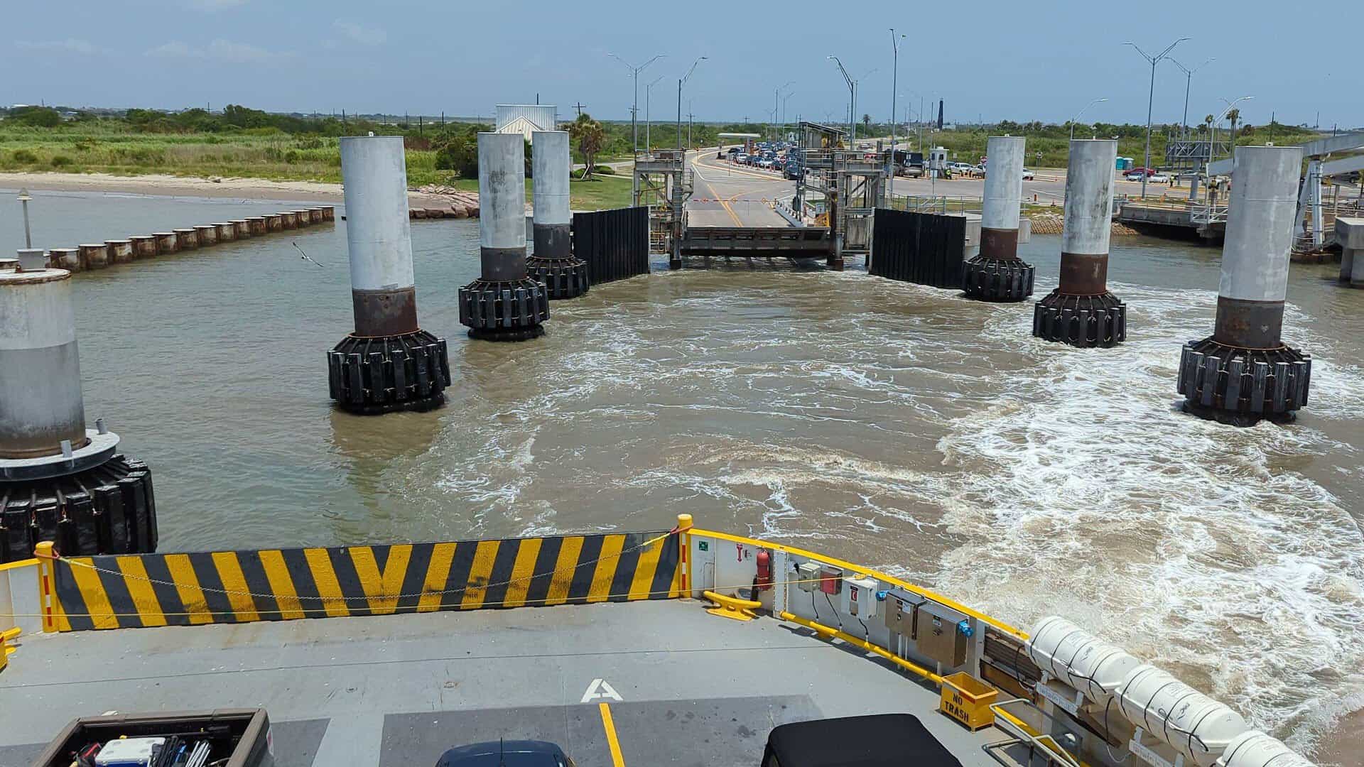 The ferry bow approaching the Port Bolivar landing between the mooring pilings