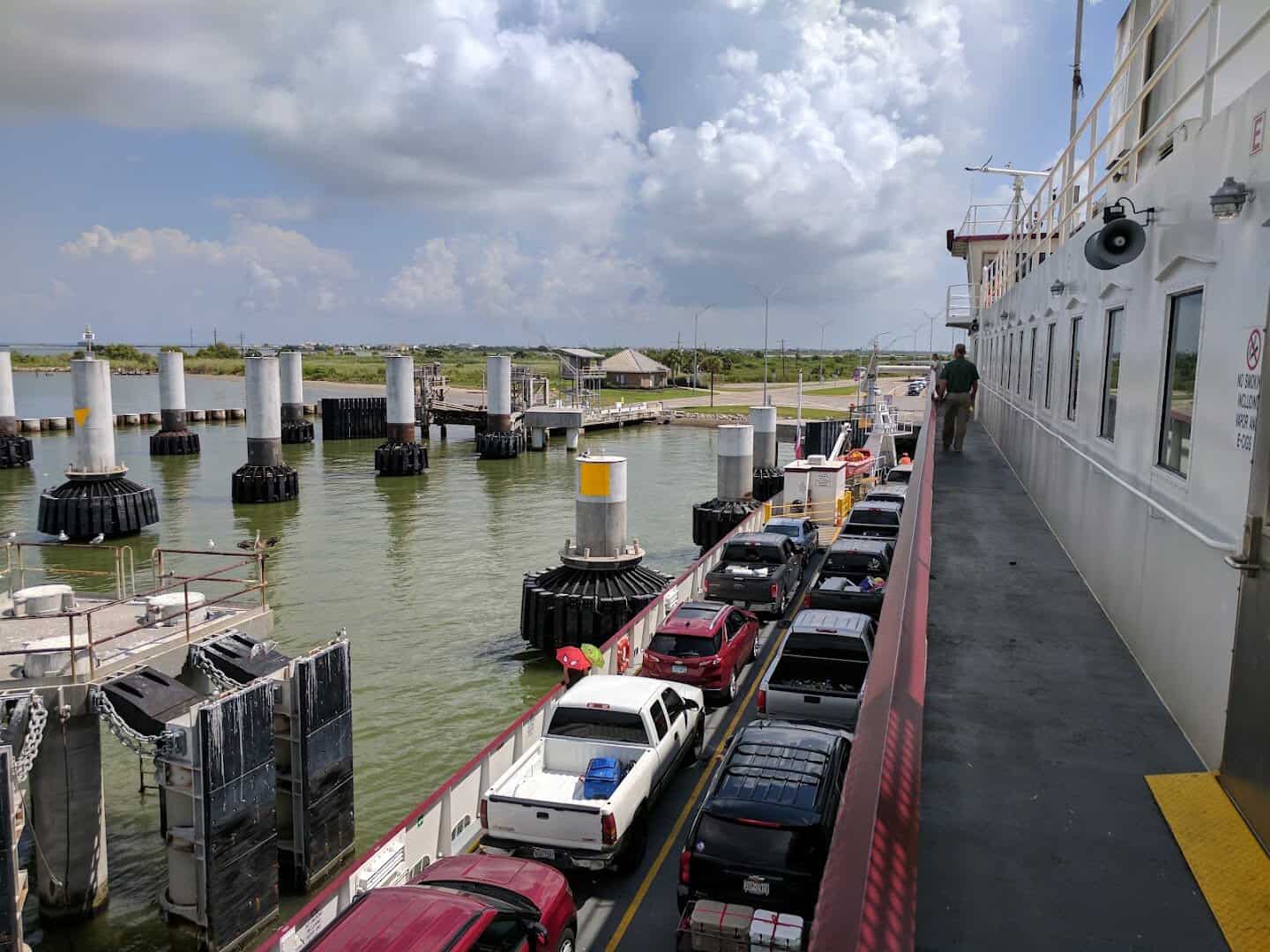 View along the ferry deck as the boat pulls into the Port Bolivar landing pilings