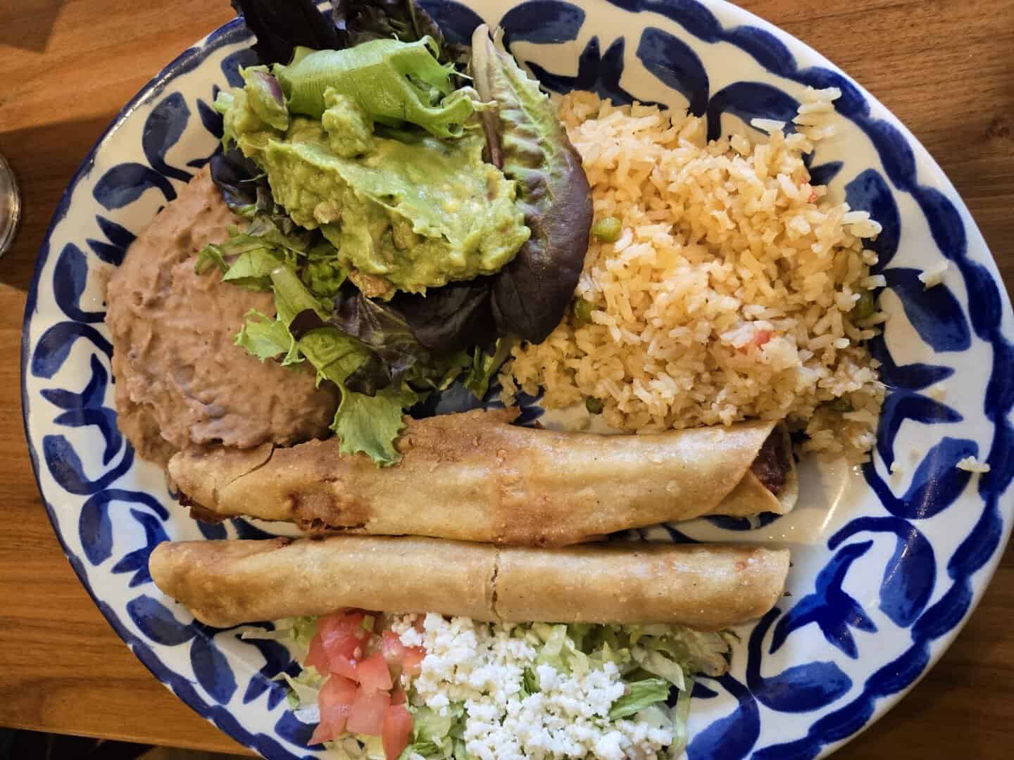 Crispy flautas with rice, refried beans and guacamole at Mi Familia at the Rim in San Antonio