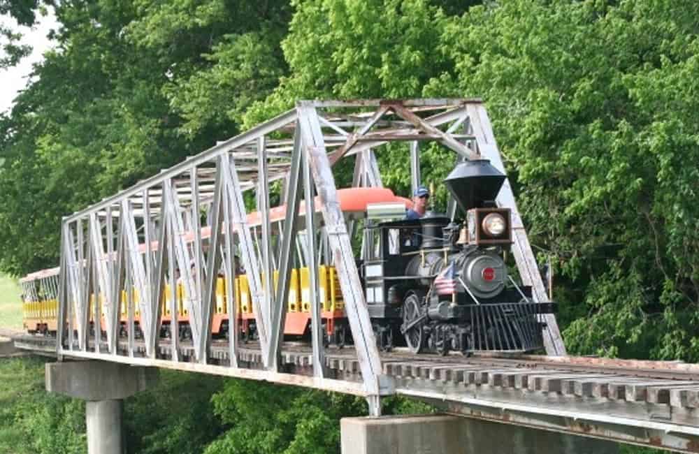 Forest Park Miniature Railroad train crossing a steel trestle over the Trinity River in Fort Worth