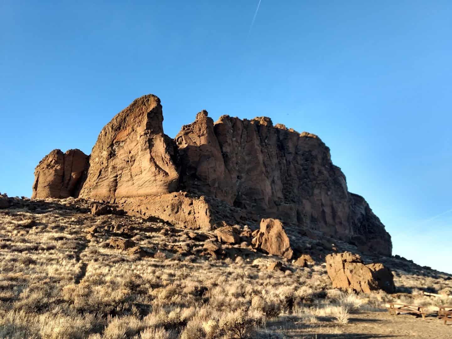 The fortress-like walls of Fort Rock rising from the high desert in Lake County, Oregon