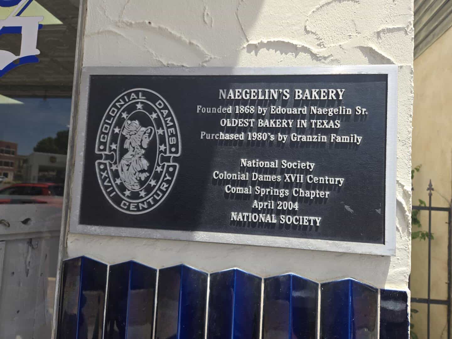Historical plaque marking Naegelin's Bakery as founded in 1868 in New Braunfels