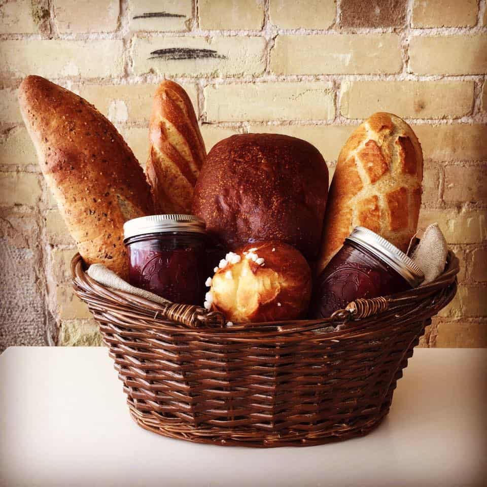 Basket of fresh French baguettes and breads at La Boulangerie in San Antonio