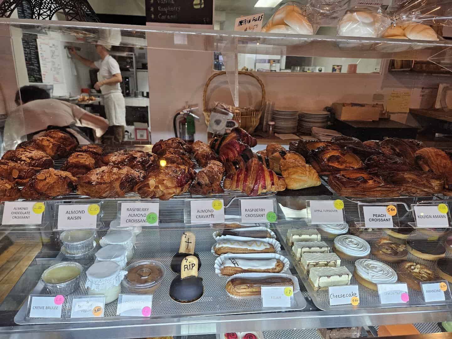 Display case full of French pastries and tarts at La Boulangerie in San Antonio