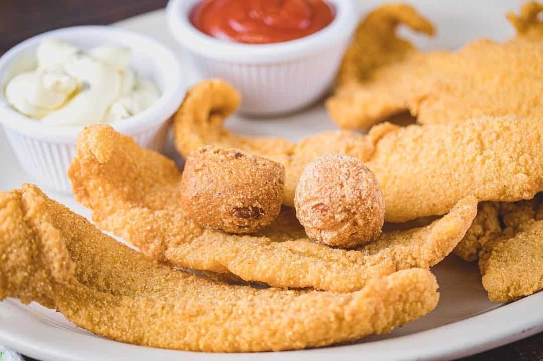 Close-up of fried catfish filets and hush puppies at Mels Country Cafe in Tomball, Texas