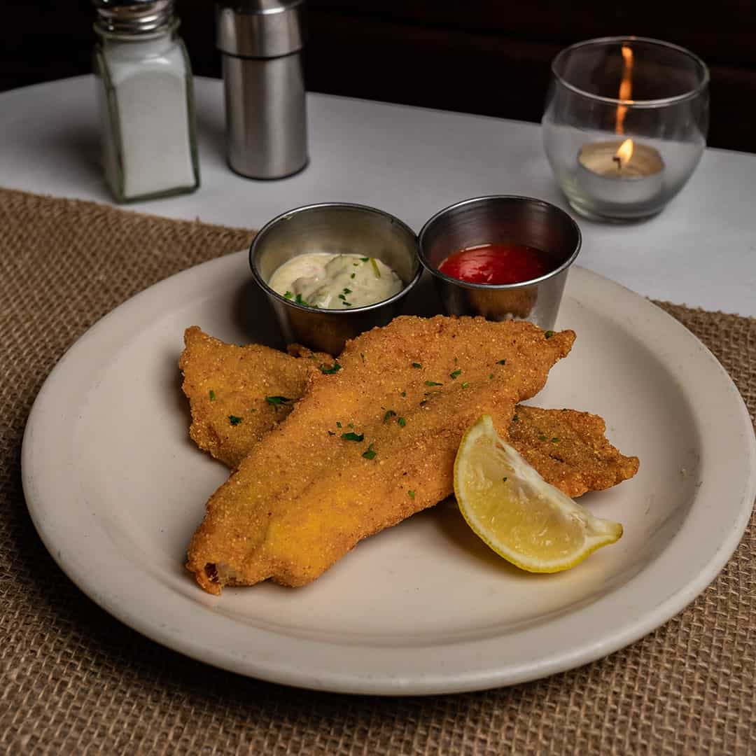 Fried catfish with lemon and dipping sauces at Celebration Restaurant in Dallas