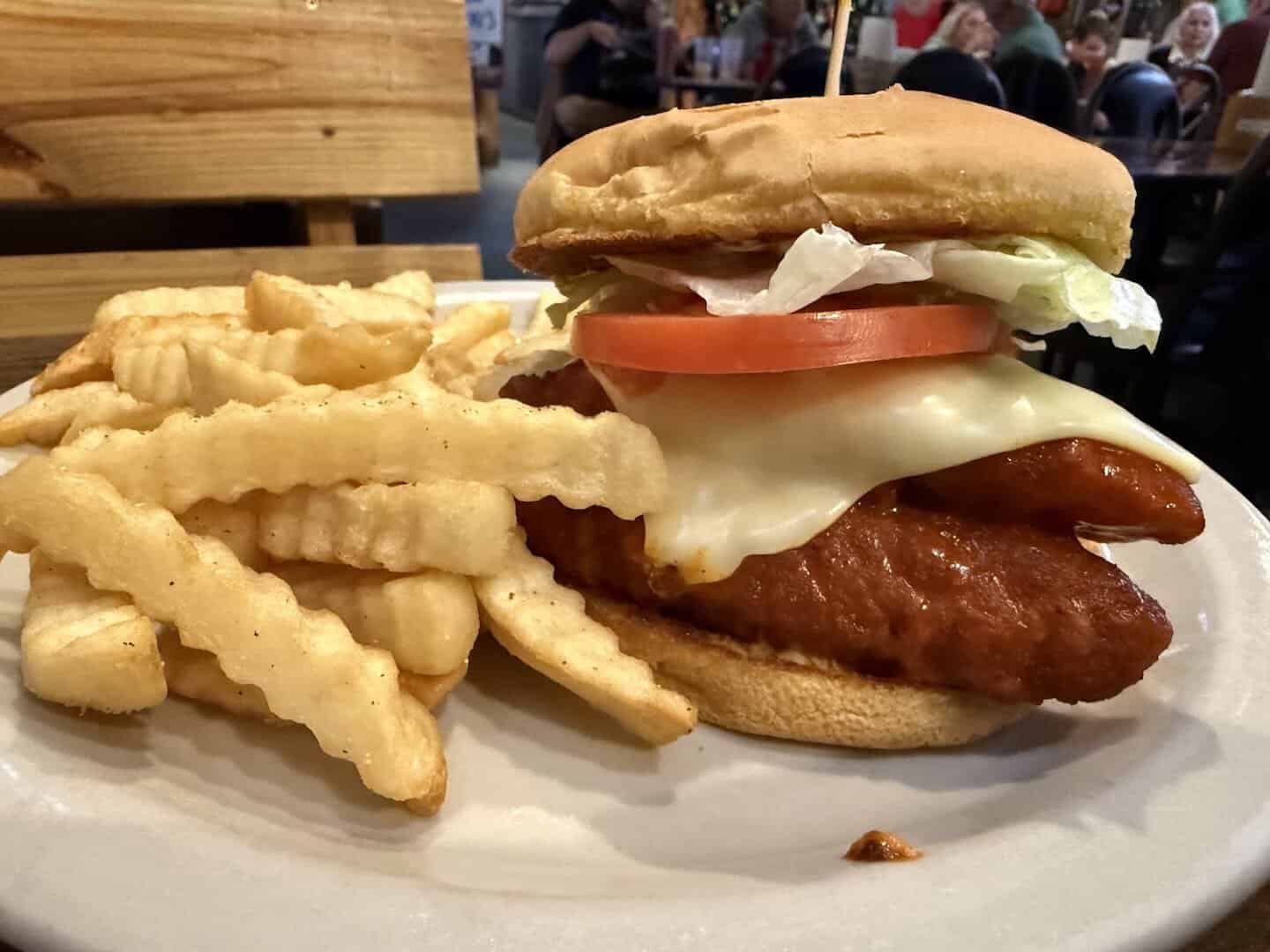 A fried chicken sandwich with cheese, lettuce and tomato and crinkle fries at Bebo's and Kathy's Cafe