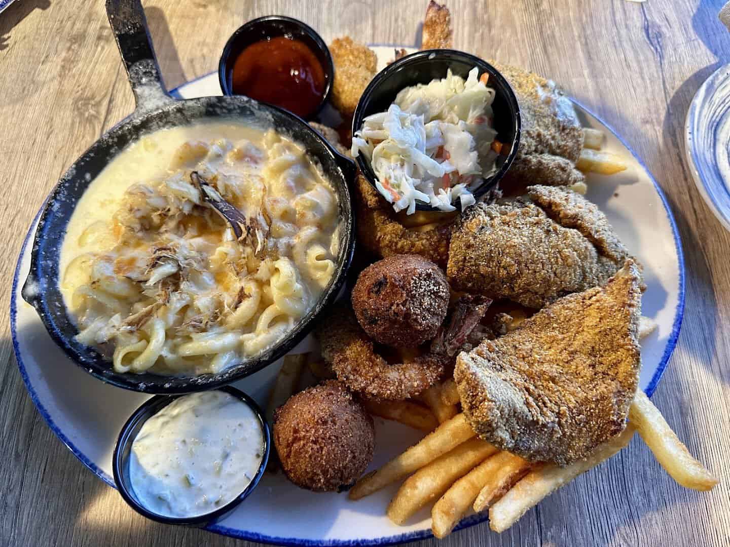 Fried Gulf seafood combo platter with hush puppies and fries at Katie's Seafood House