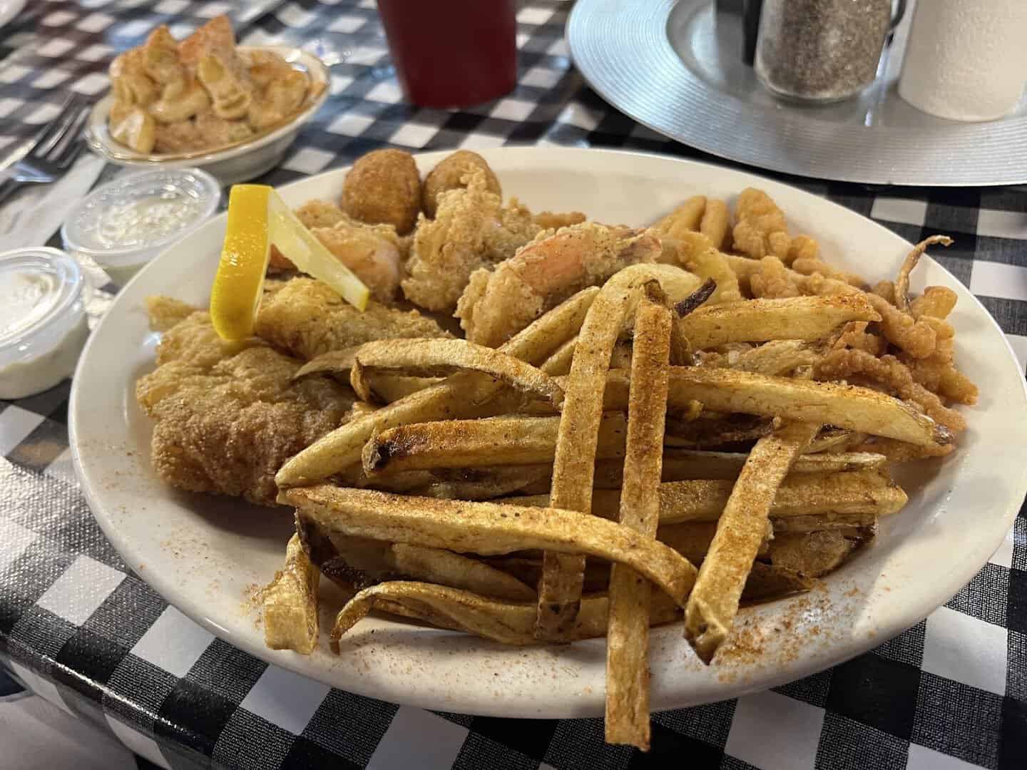 Fried seafood combo platter with catfish, shrimp and fries at Mel's Diner in Mingus, Texas