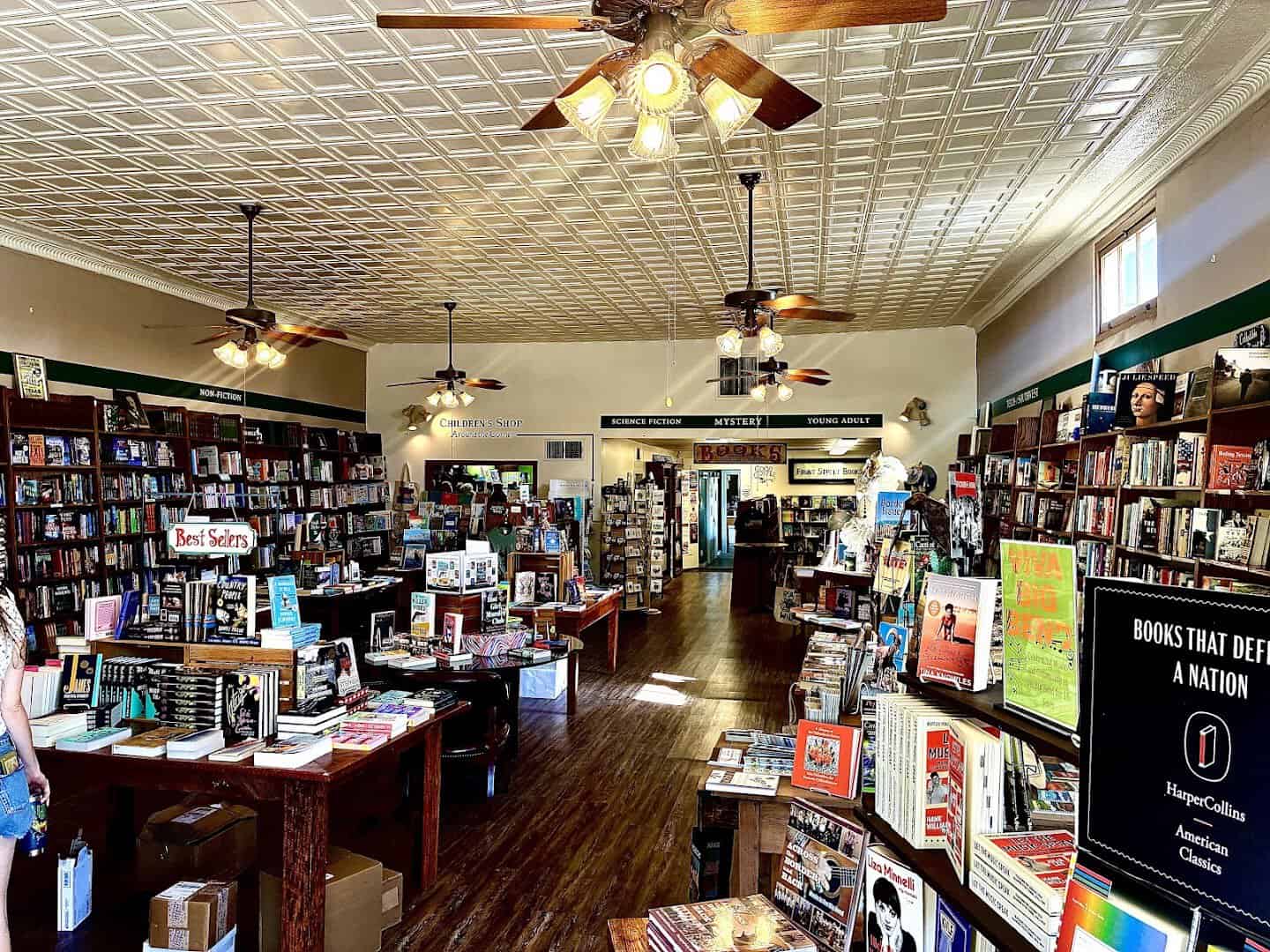 Interior with tin ceiling and book tables at Front Street Books in Alpine