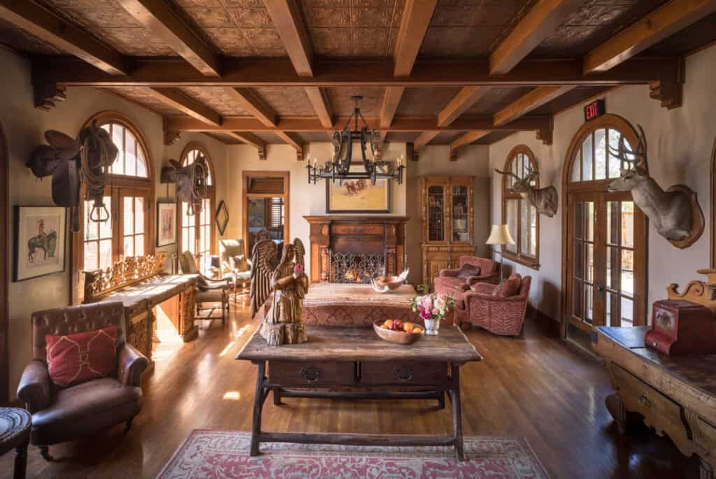 Historic lobby of the Gage Hotel with oak floors, beamed ceiling and fireplace