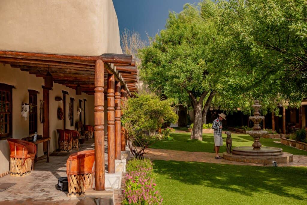 Covered porch and courtyard fountain at Los Portales, Gage Hotel