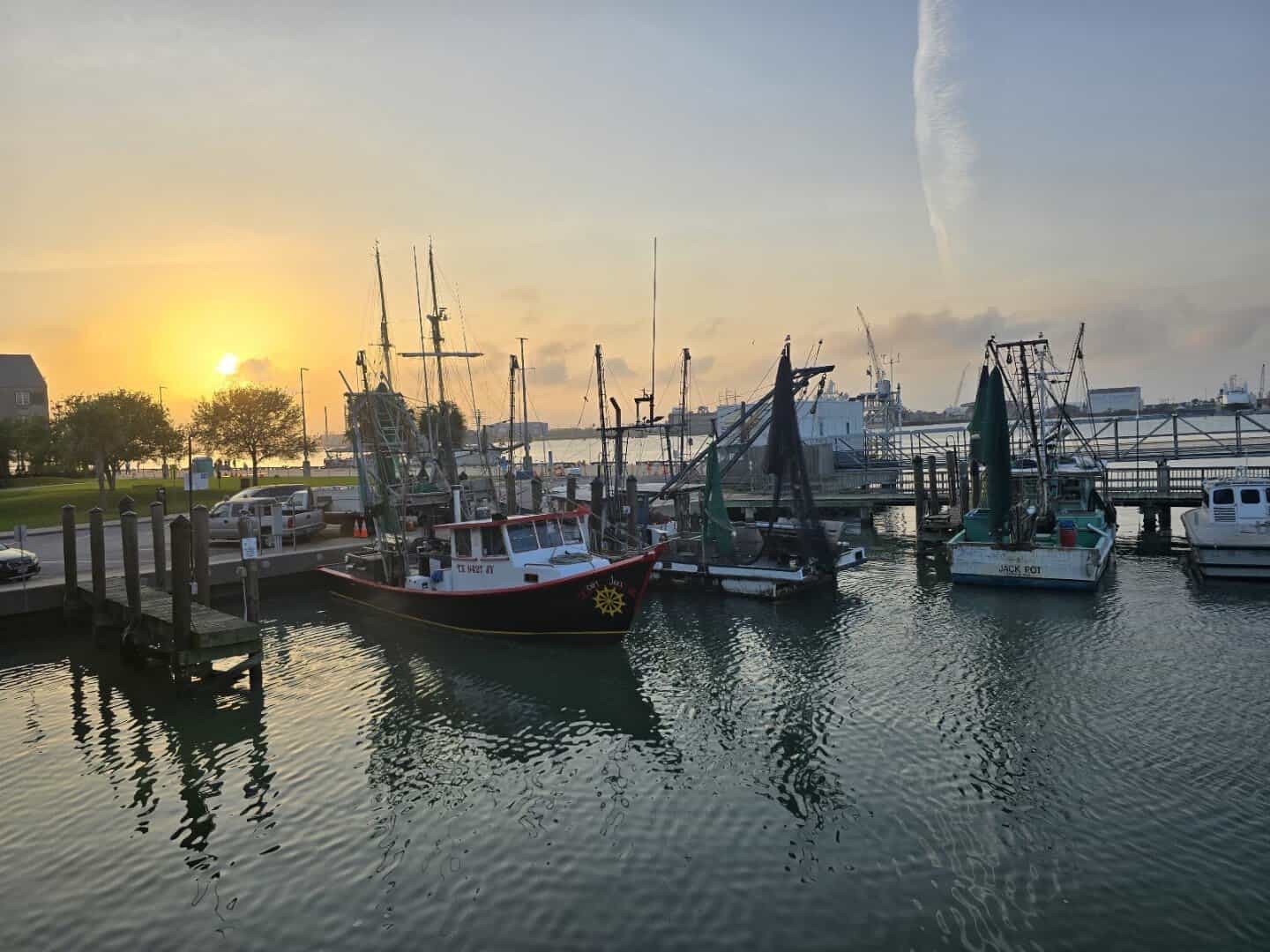 Sunset over shrimp boats at the Galveston harbor near Katie's Seafood House