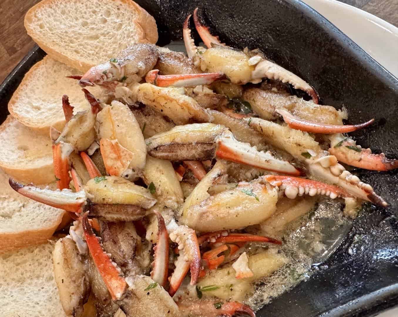 Garlic butter blue crab claws with baguette at Katie's Seafood House in Galveston