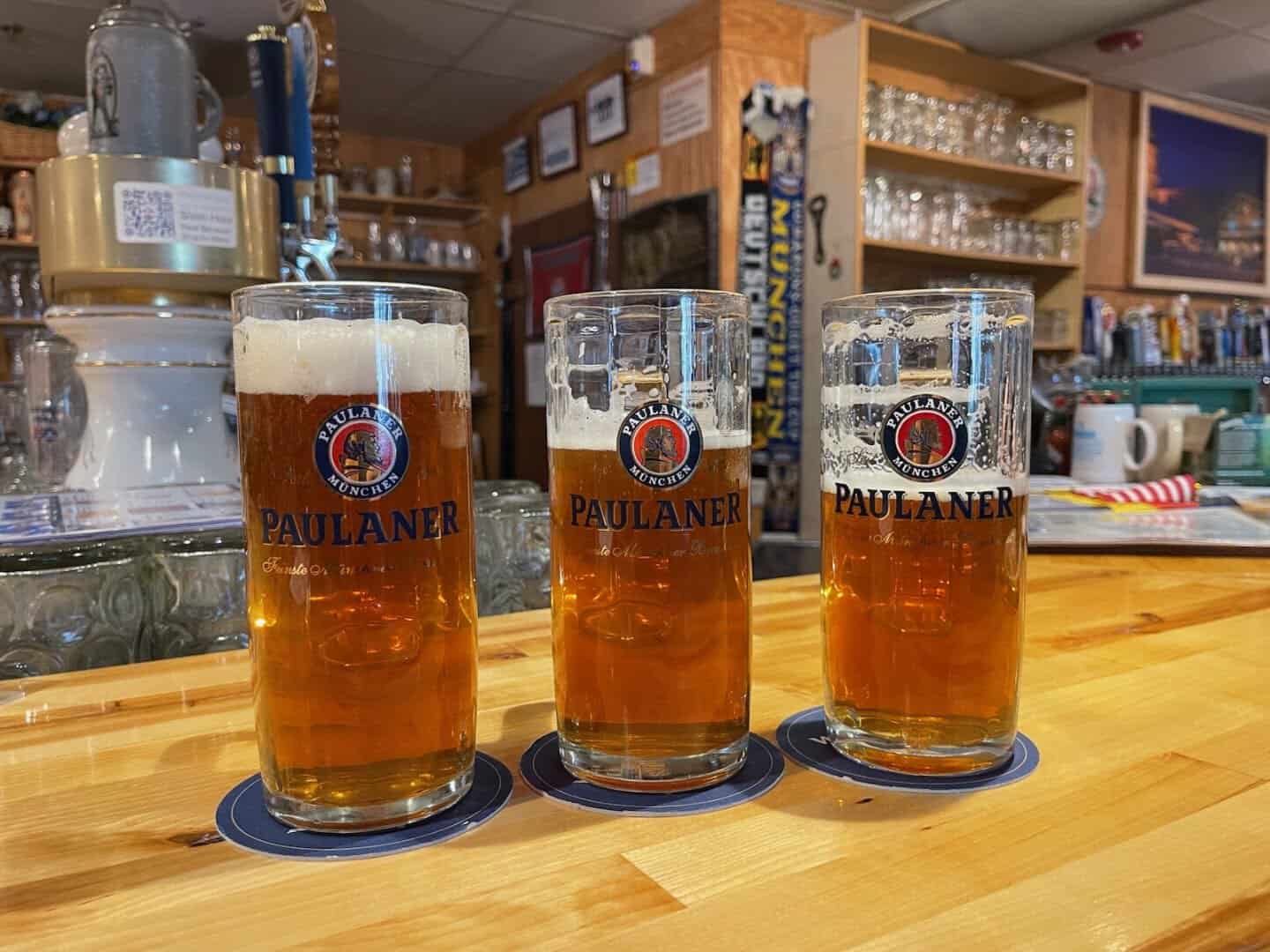 German draught beers below a wall of personalized steins at Bavarian Grill in Plano, Texas