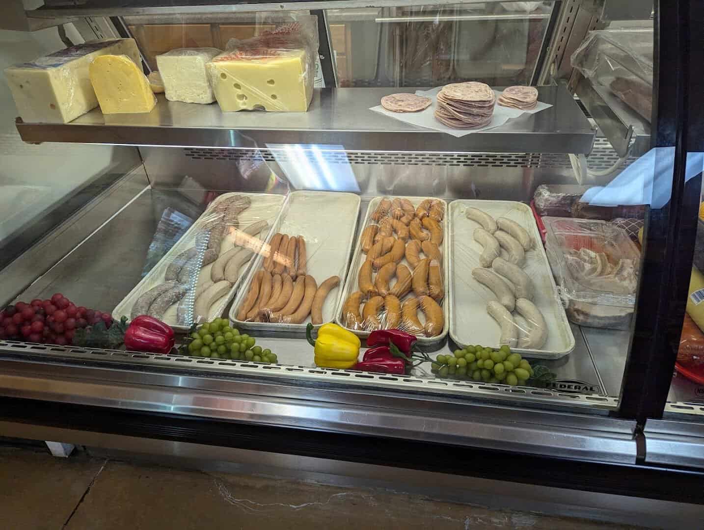 German deli case with sausages and cheeses at Pfeifer's German Bakery