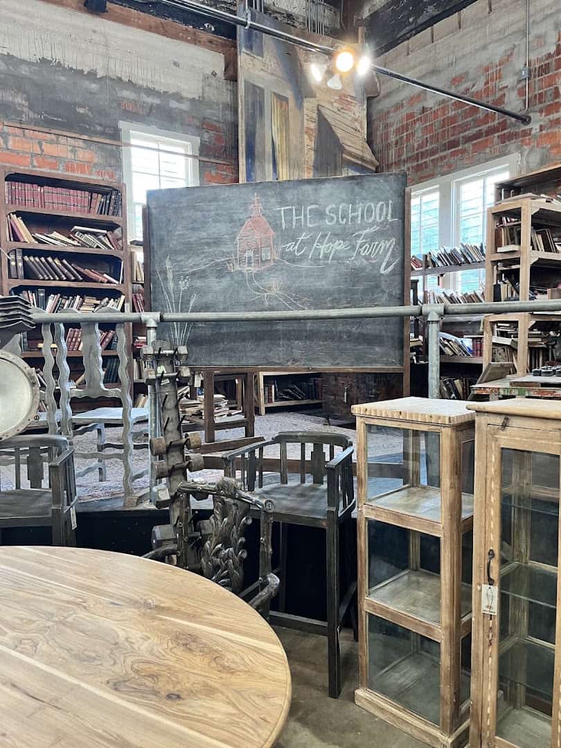 Glass display cases, a chalkboard and shelves of old books inside Carol Hicks Bolton Antiques in Fredericksburg