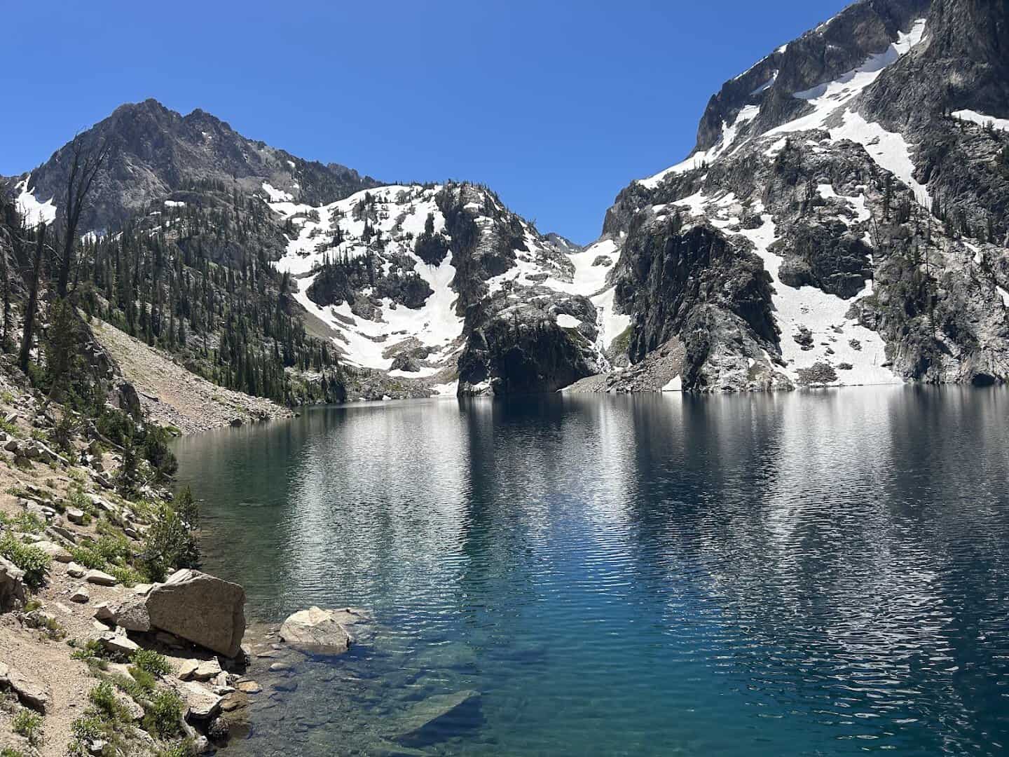Vivid blue Goat Lake ringed by Sawtooth peaks, Idaho