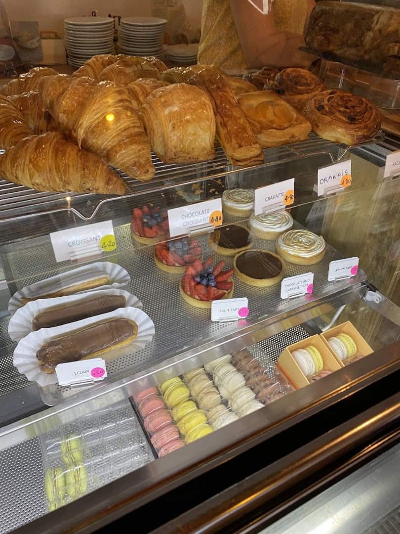 Golden croissants and pastries in the display case at La Boulangerie in San Antonio