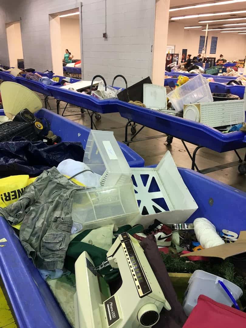 Goods sold by the pound on blue tables at the Goodwill Outlet in Fort Worth