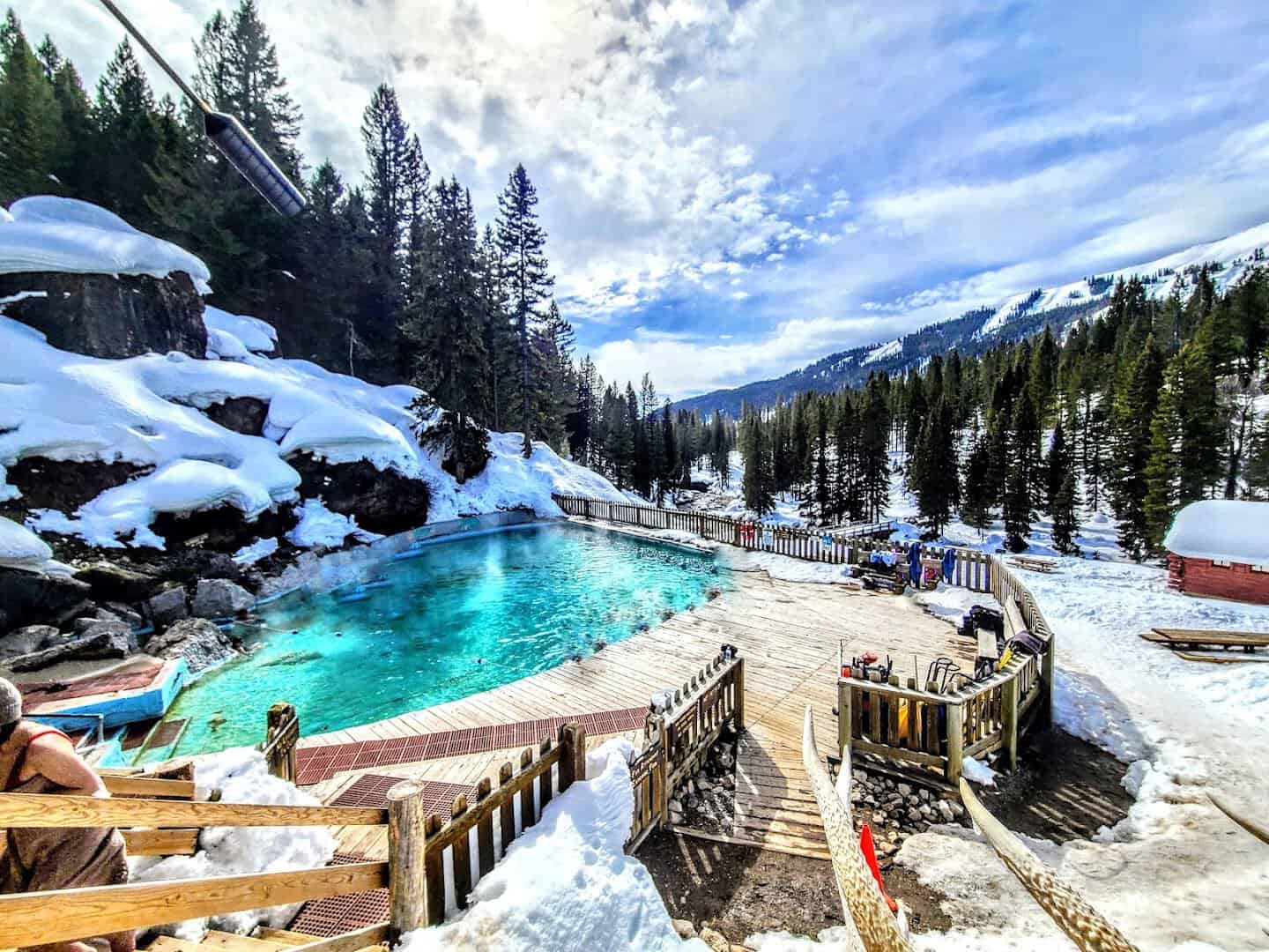 Steaming turquoise Granite Hot Springs pool ringed by snow and pines near Jackson, Wyoming