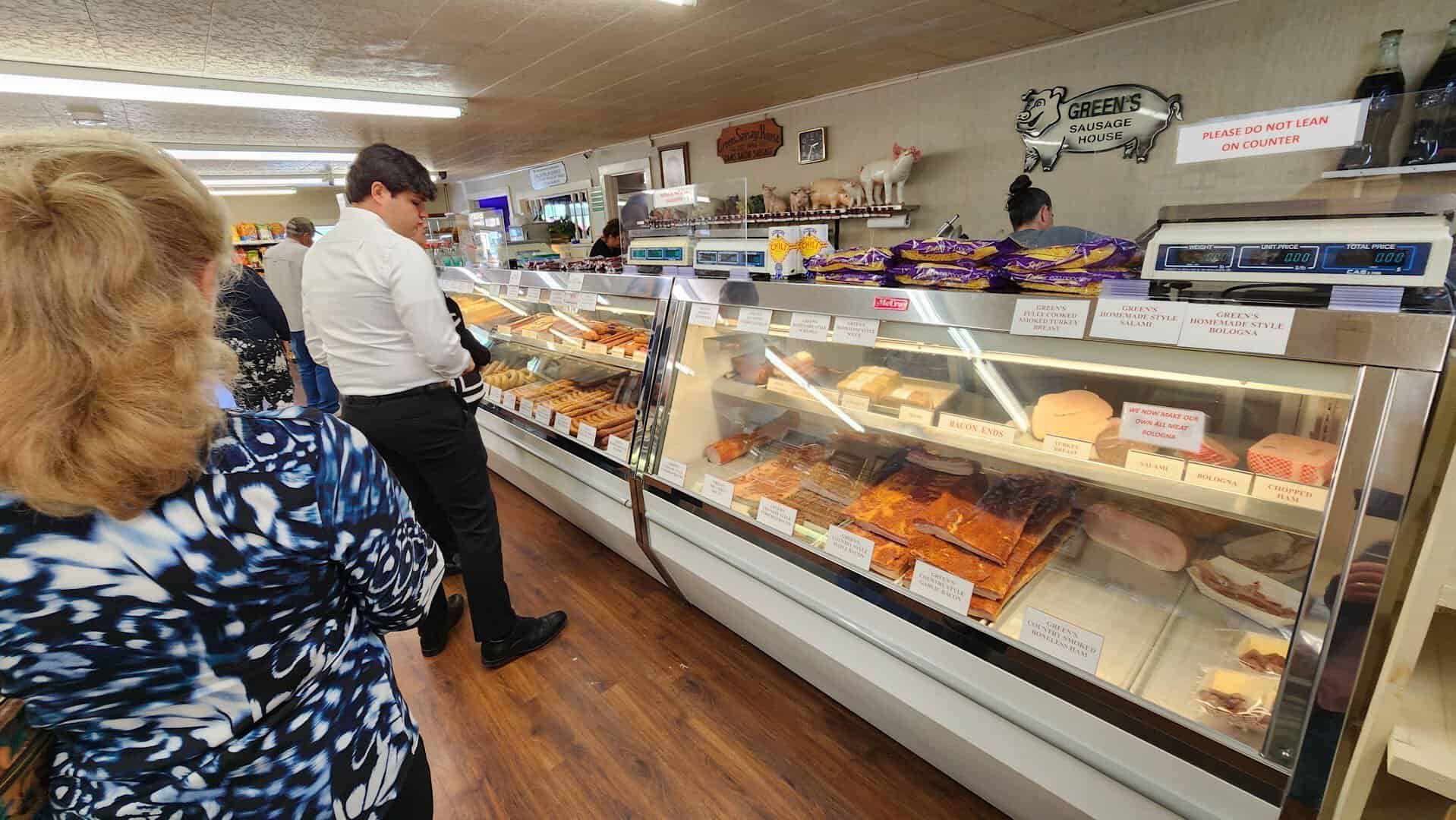 Green's Sausage House deli counter with bacon, ham, bologna, and salami ready to slice