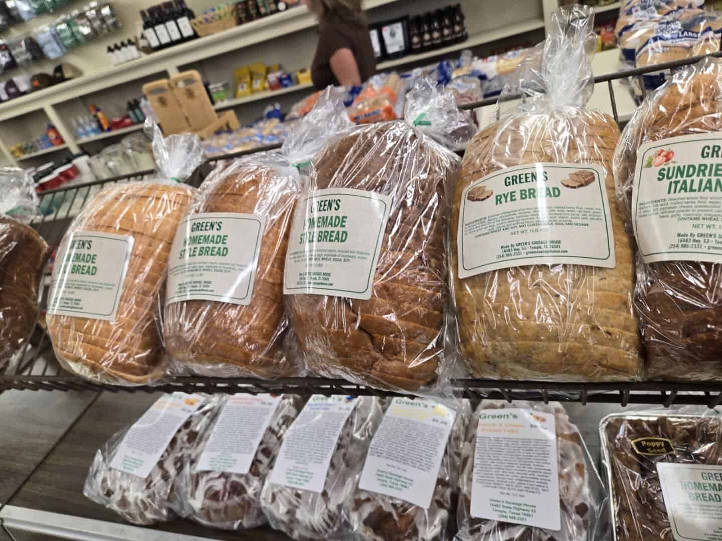 Loaves of Green's homemade rye and sundried tomato bread on the bakery shelf