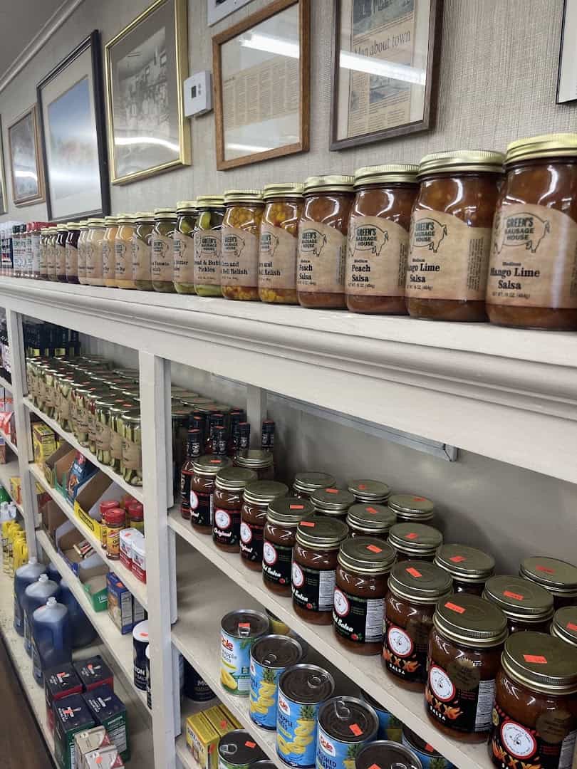 Shelves of Green's Sausage House peach salsa, mango lime salsa, and bread and butter pickles