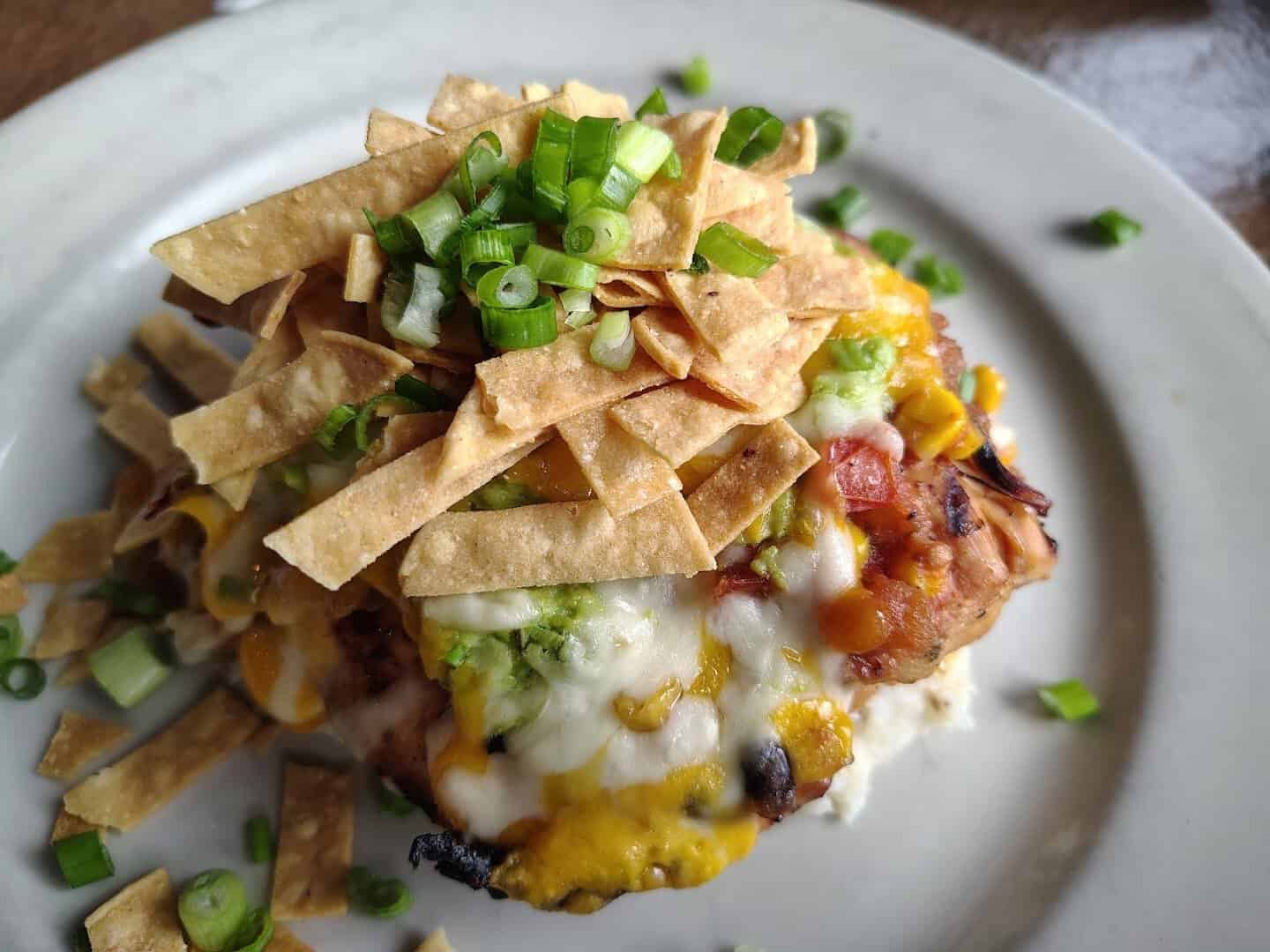 Grilled chicken topped with cheese, guacamole and tortilla strips at Gruene River Grill in New Braunfels