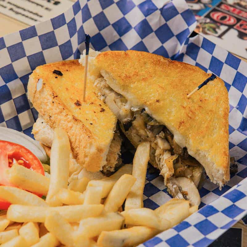 Grilled melt stacked on Texas toast with fries at Hill Country Cupboard