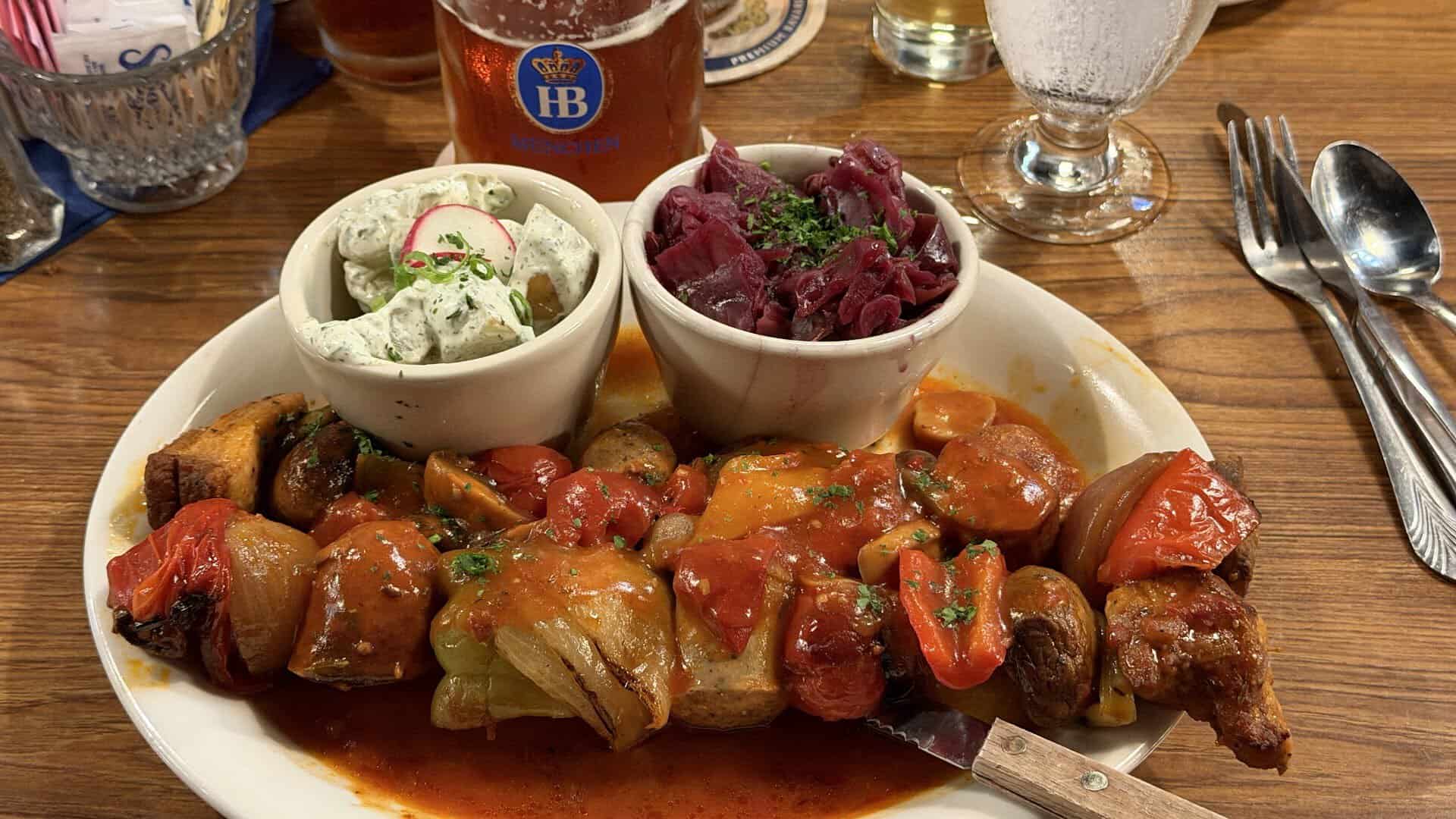 Grilled skewers with red cabbage and potato salad at Bavarian Grill in Plano