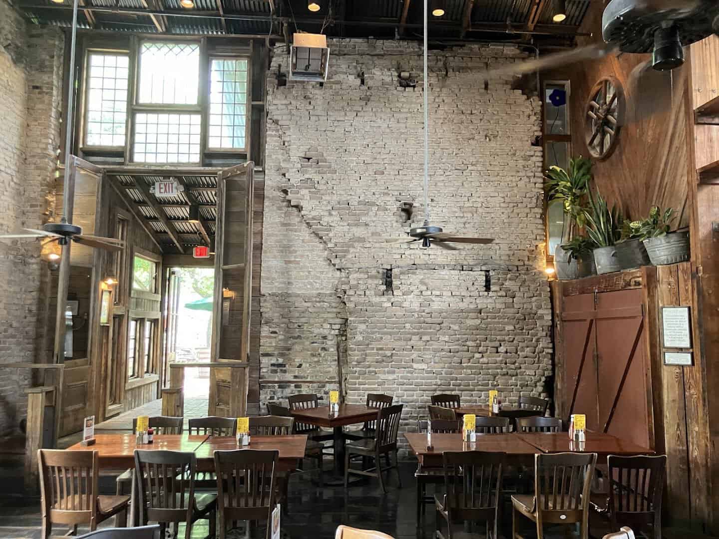 Rustic brick-walled interior dining room inside the old Gruene cotton gin