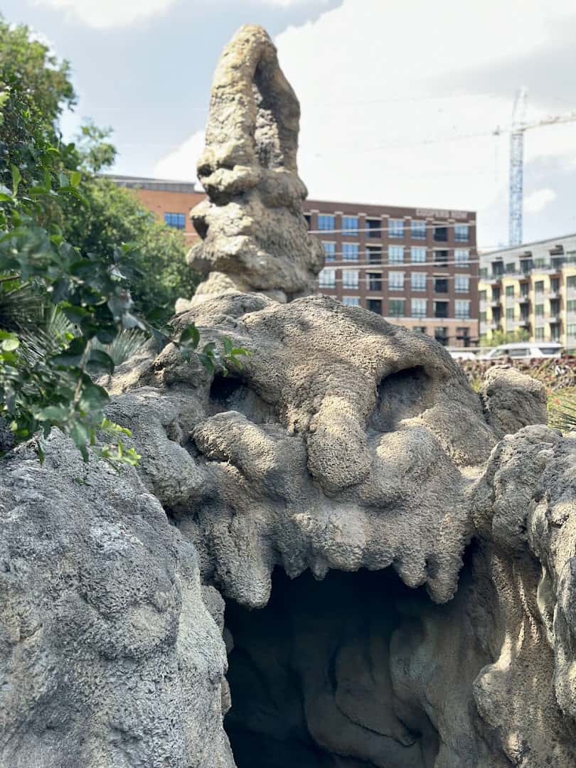 Carved jaguar face and spire above the cave mouth at The Grotto in San Antonio