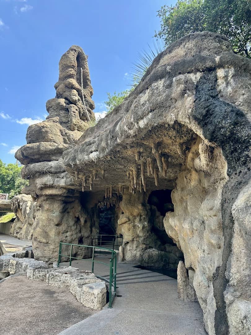 The Grotto's hand-carved stone cave with stalactites and a spire on the San Antonio River Walk