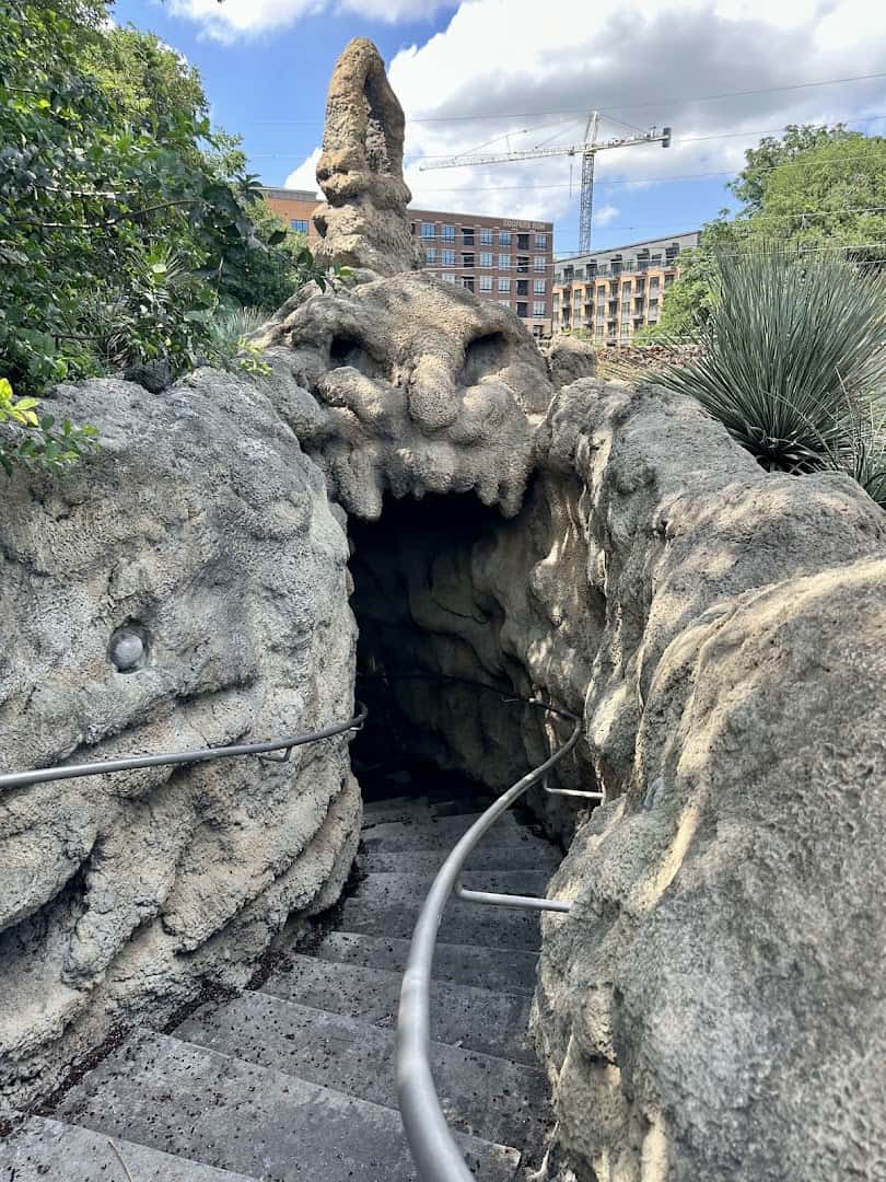 Stairway descending through the carved jaguar-head entrance of The Grotto in San Antonio