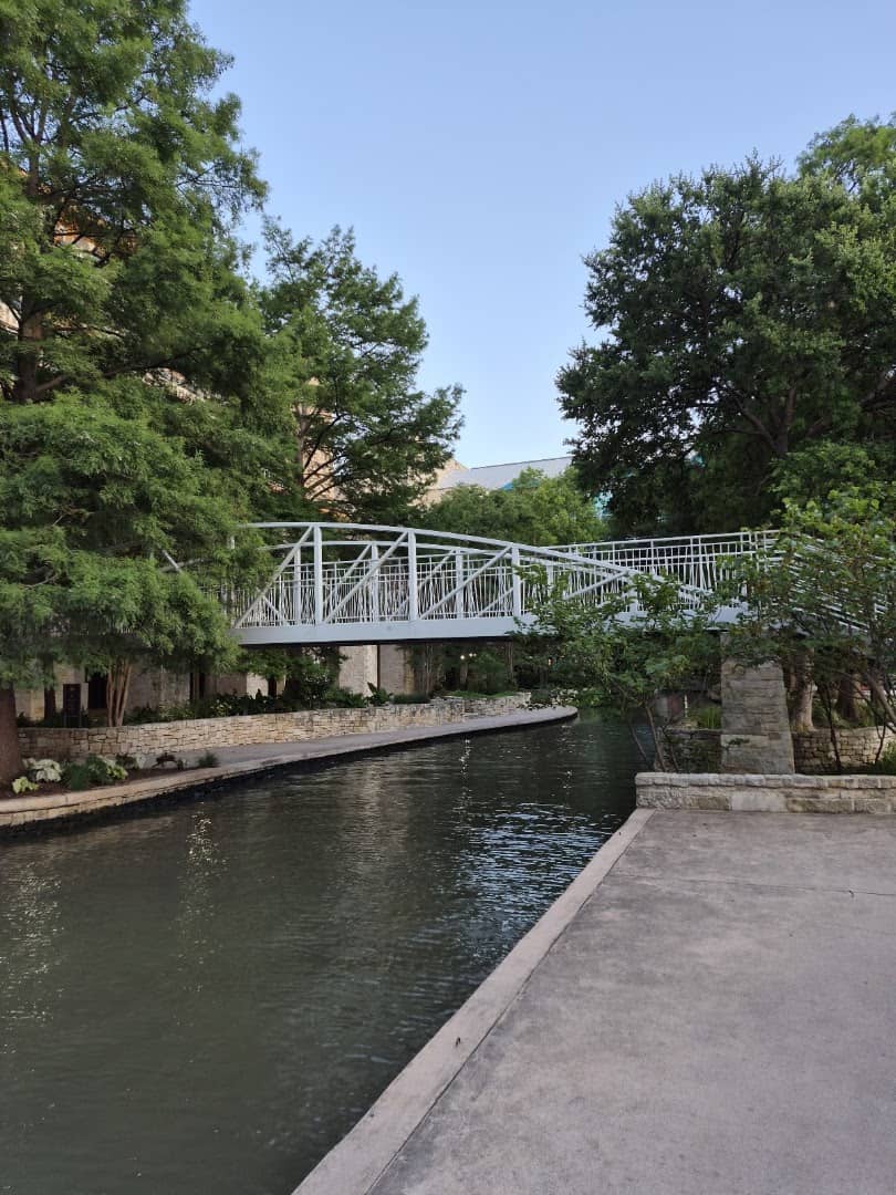 White footbridge over the Museum Reach of the San Antonio River Walk near The Grotto
