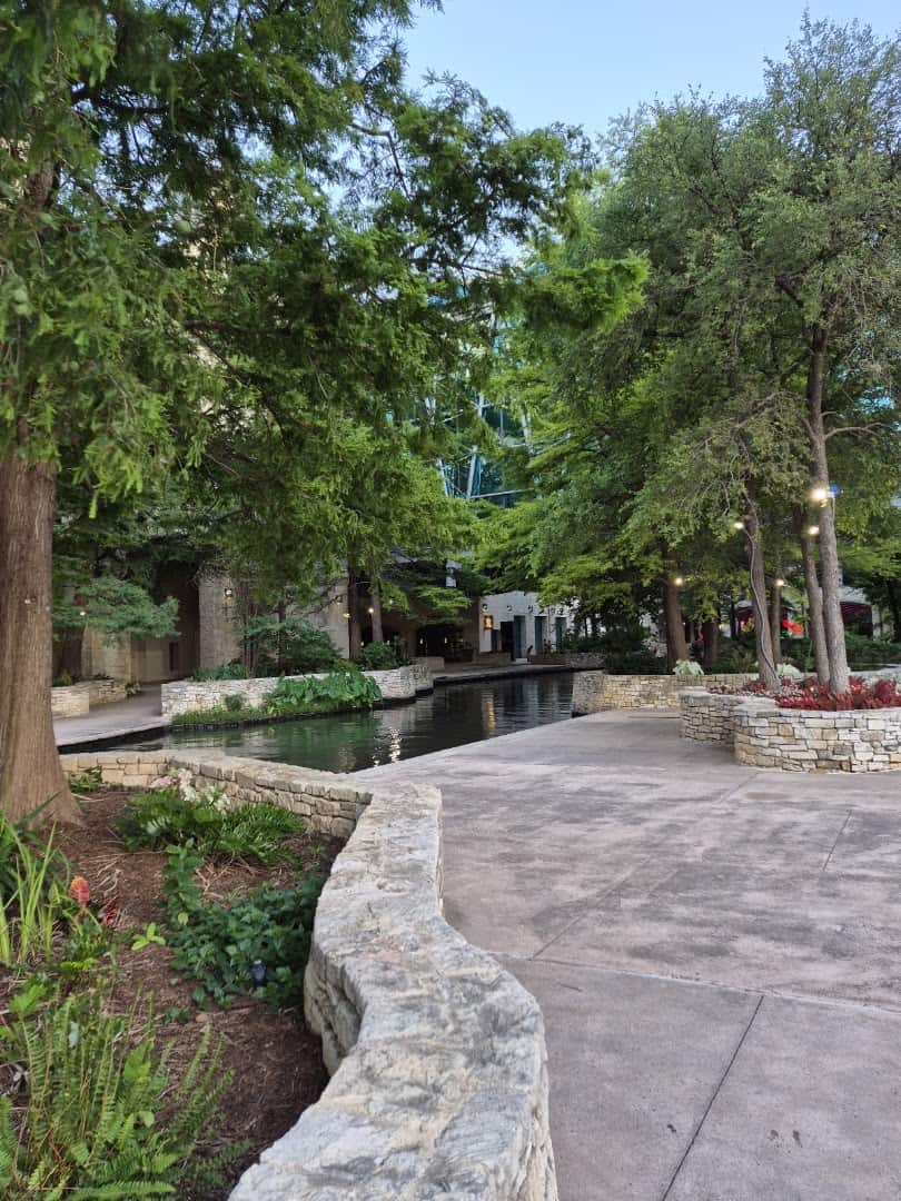 A stone-walled plaza and path along the Museum Reach near The Grotto in San Antonio