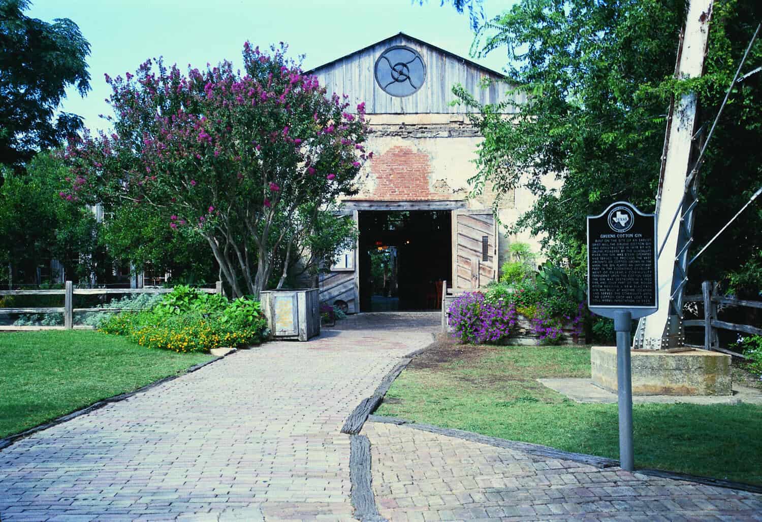 Front of the 1878 Gruene cotton gin with its Texas historical marker