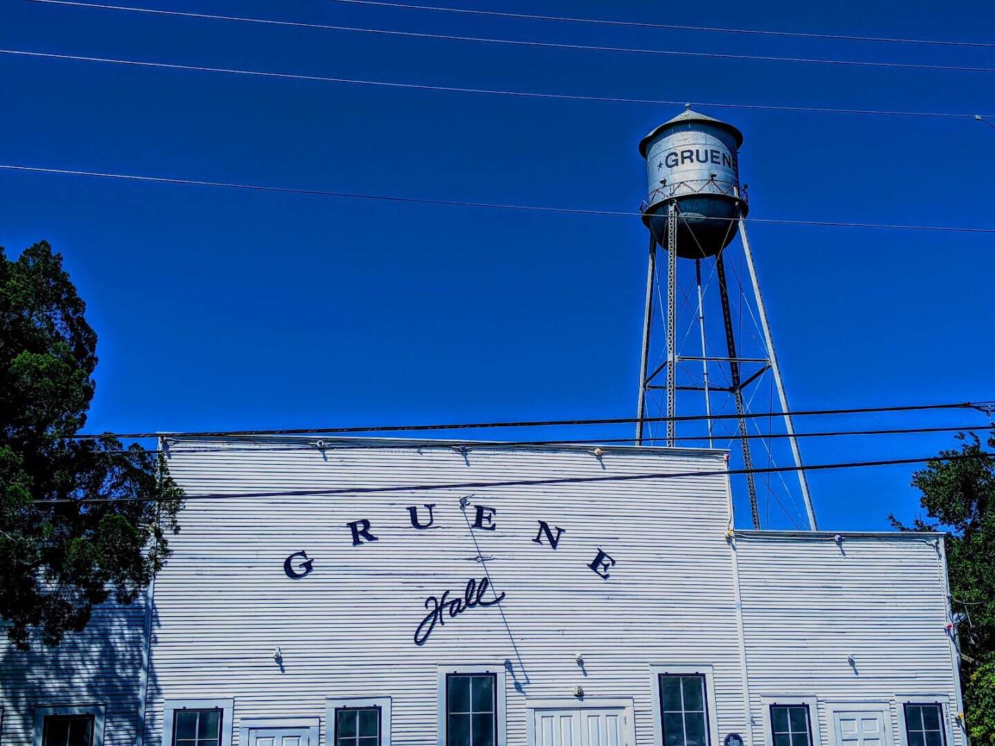 Gruene Hall and the historic Gruene water tower against a blue sky