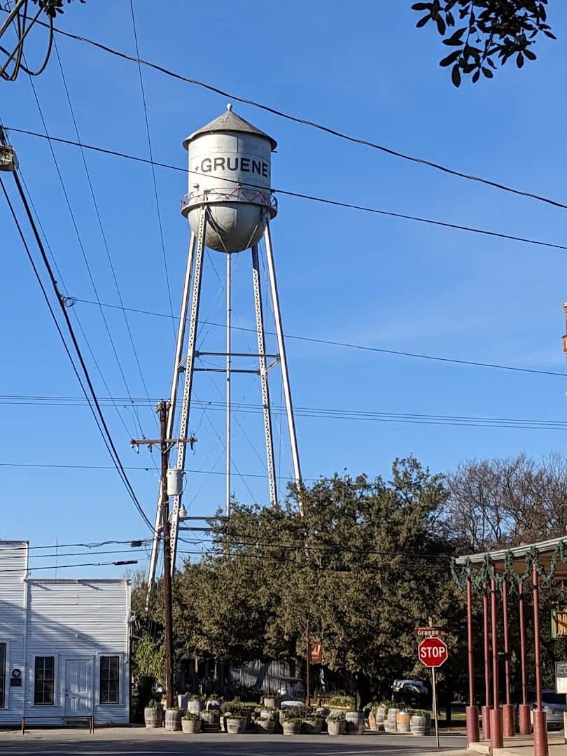 The silver Gruene water tower rising over the historic district