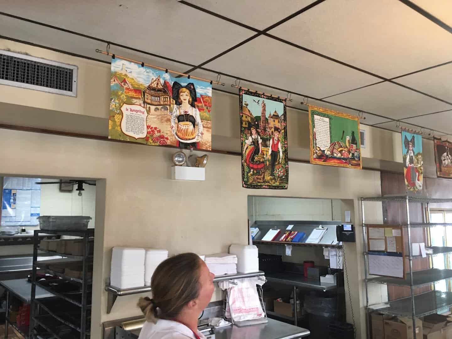 Framed photos and menu inside Haby's Alsatian Bakery in Castroville, Texas