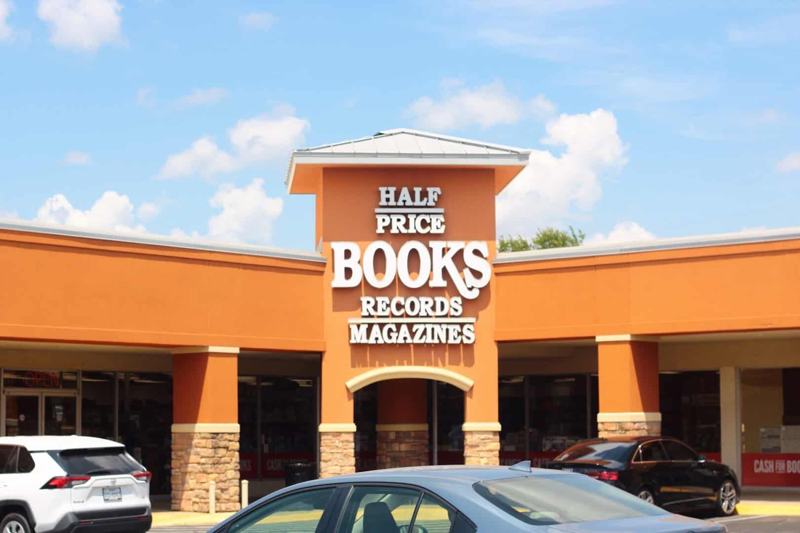 The orange storefront and sign of the Half Price Books flagship on Northwest Highway in Dallas