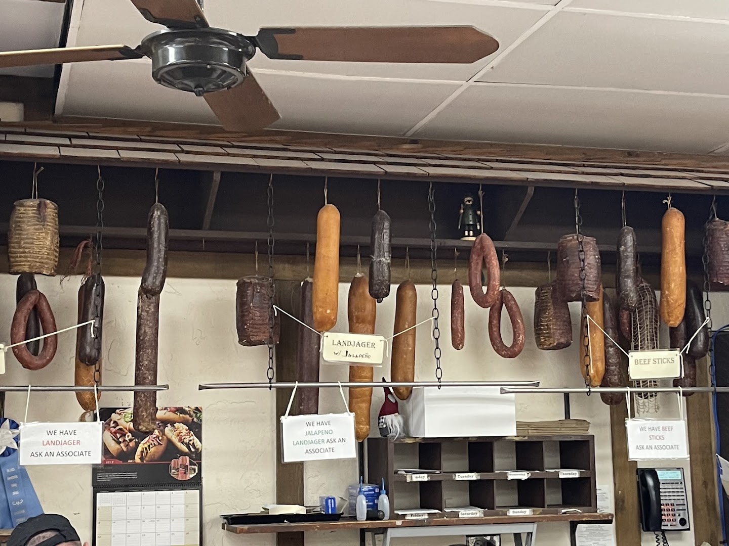 House-made landjager and smoked sausages hanging behind the counter at Kuby's Sausage House in Dallas