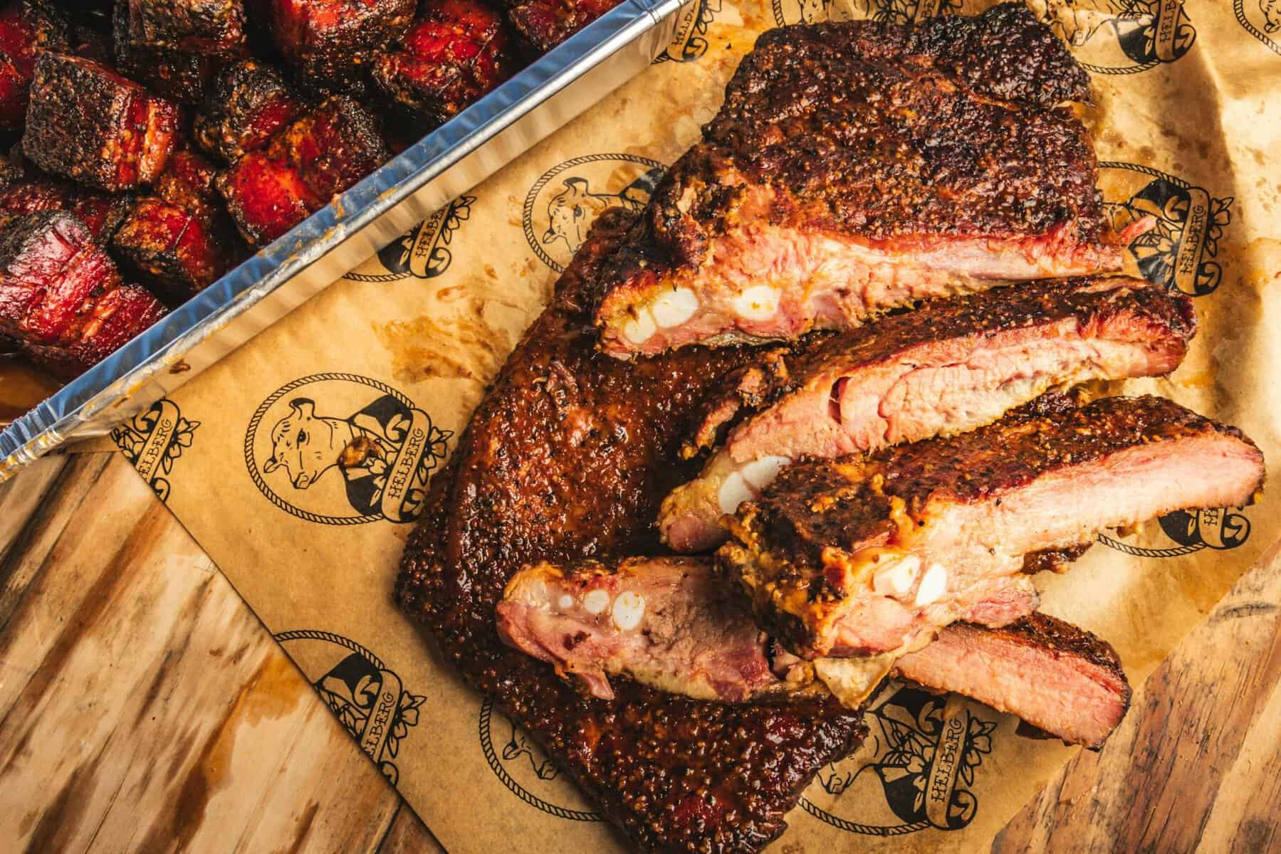 Sliced brisket and ribs on a board at Helberg Barbecue in Woodway, Texas