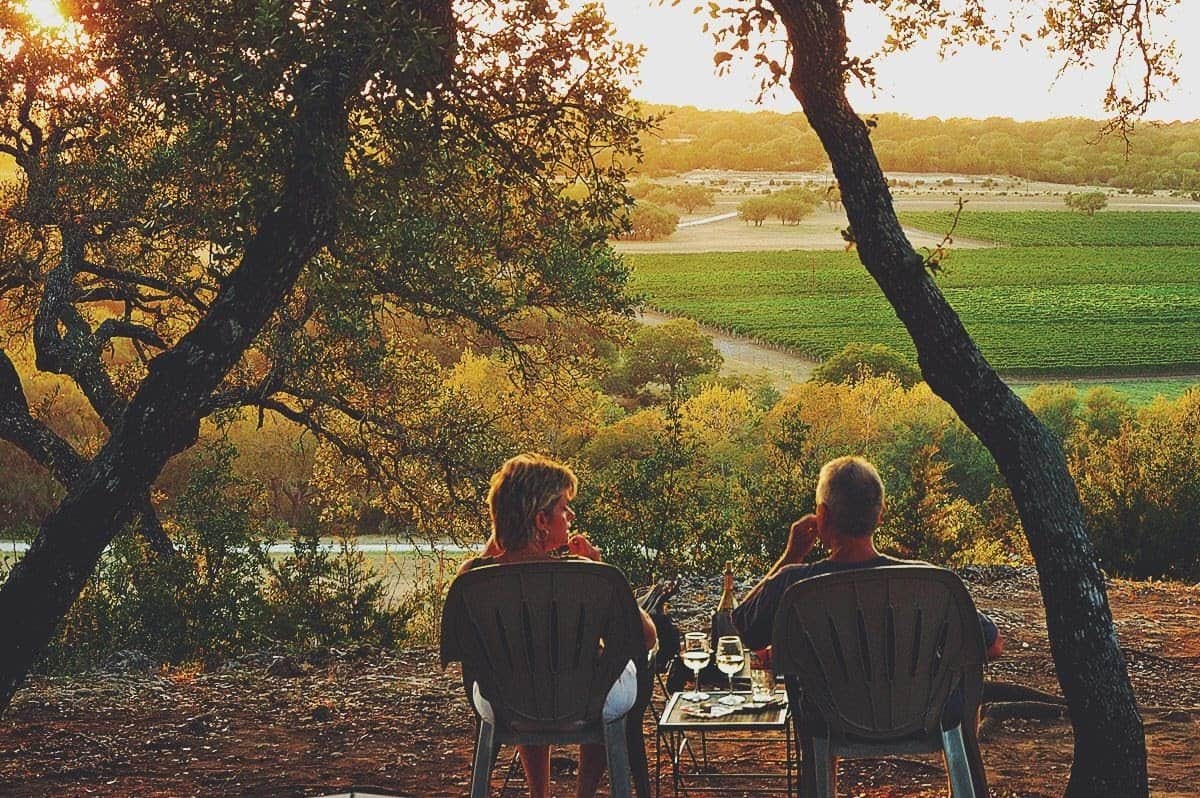 Two people watching the sunset over the Texas Hill Country near Driftwood