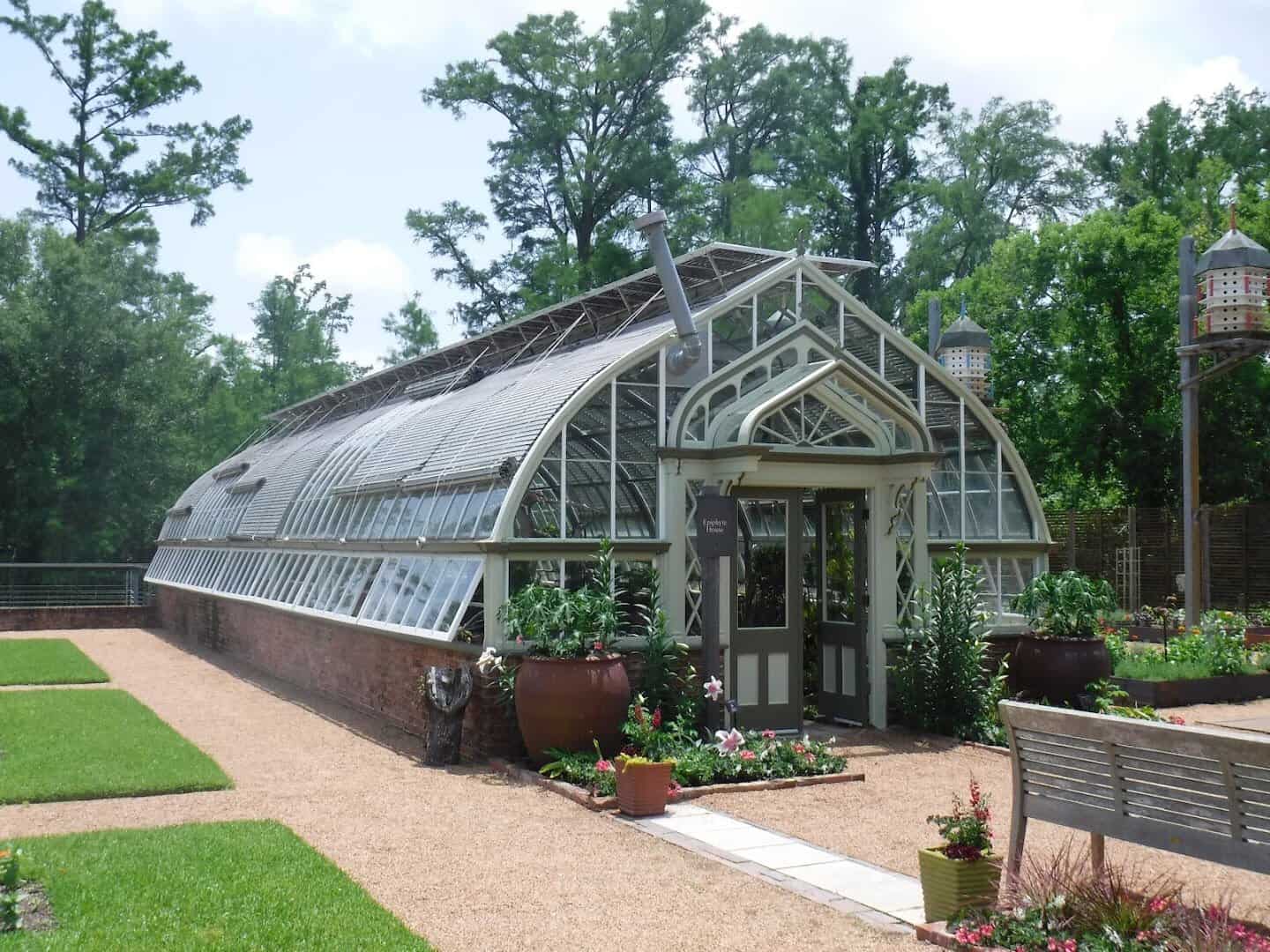 Historic greenhouse building and brick walkway at Shangri La Botanical Gardens in Orange, Texas