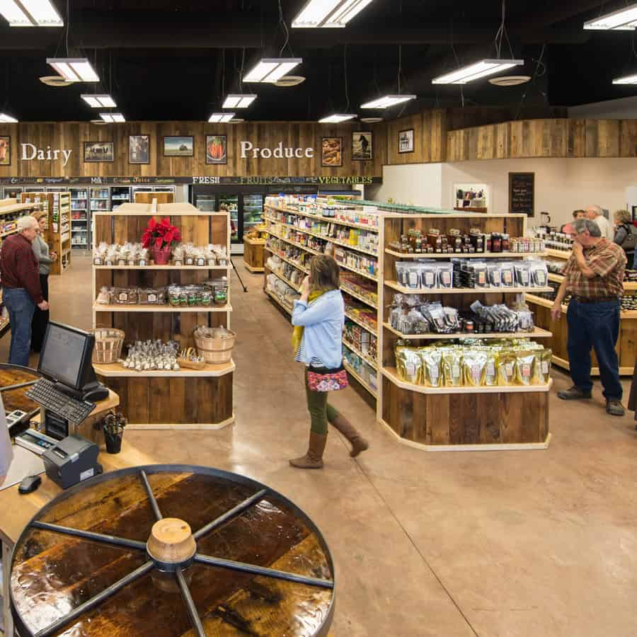Inside Homestead Heritage Market with dairy and produce sections and shelves of goods near Waco, Texas