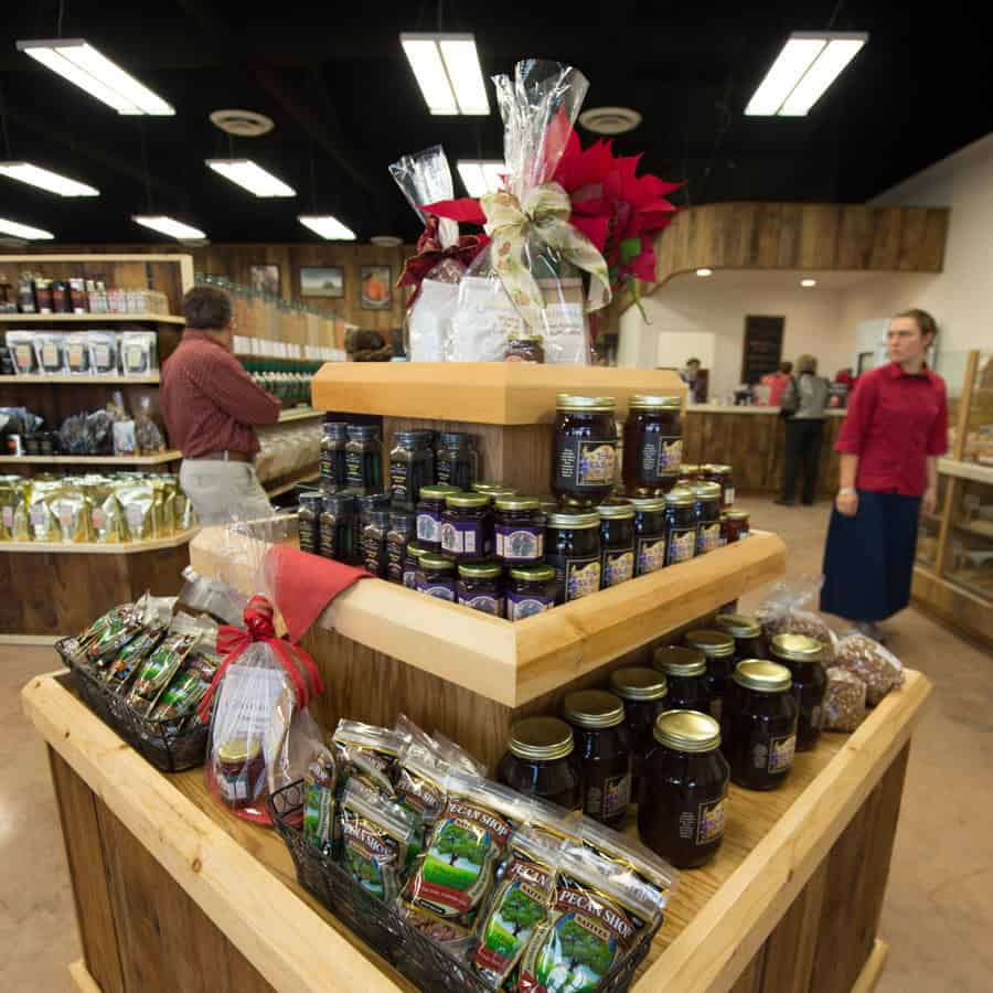 Display of homemade jams, preserves, pecans and gift baskets packed inside Homestead Heritage Market near Waco, Texas